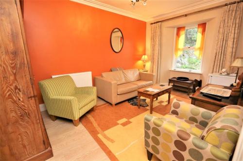 a living room with a couch and a chair at Ascot House Hotel in Torquay