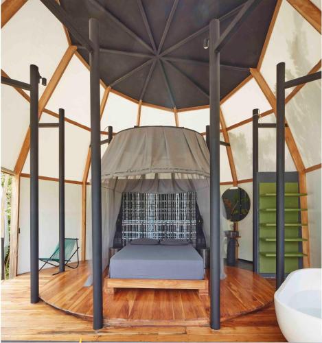 a room with a bed in a tent at Art Villas Costa Rica, Villas & Glamping in Uvita
