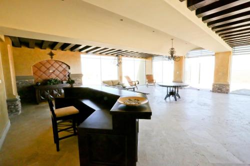 a large living room with a table and chairs at Encanto Living One Bedroom Unit by Kivoya in Puerto Peñasco