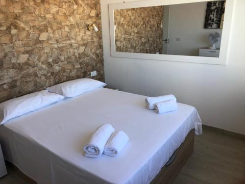 a bedroom with a bed with towels on it at Costa Adeje Apartments in Adeje