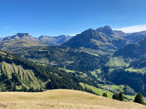 a view of a valley in the mountains at Haus Schrofenstein in Lech am Arlberg