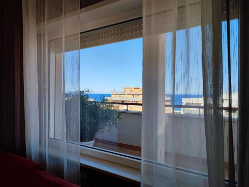 a room with a window with a view of the ocean at IsolaAzzurra in Monopoli