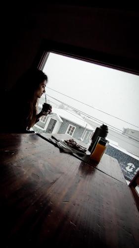 a man sitting at a table in a room at Antarctica Hostel in Ushuaia