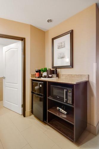 a kitchen with a microwave and a counter top at Ayres Hotel & Spa Moreno Valley/Riverside in Moreno Valley
