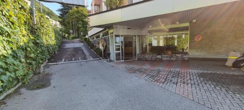 a building with a walkway in front of a building at Bianca Apartment in Bissone