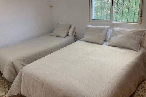 A bed or beds in a room at Casa rural con piscina / Cottage house with swimming pool