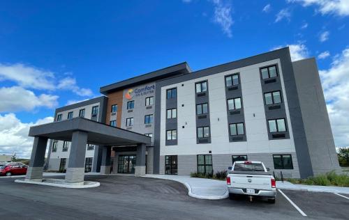 a building with a car parked in a parking lot at Comfort Inn & Suites in Carleton Place