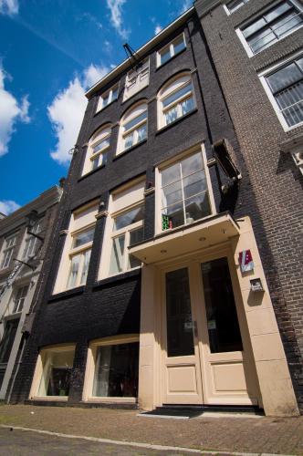a black building with a door in front of it at Amsterdam Downtown Hotel in Amsterdam