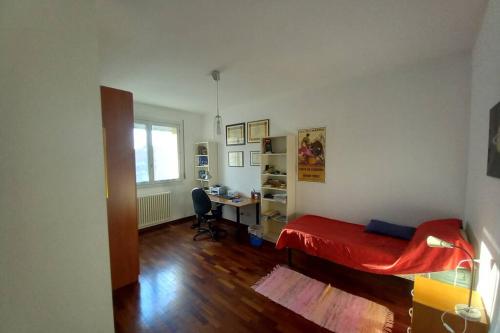 a bedroom with a desk and a bed in a room at Carachouse - Bologna in Bologna