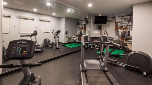 a gym with several tread machines in a room at Best Western Plus New Cumberland in New Cumberland