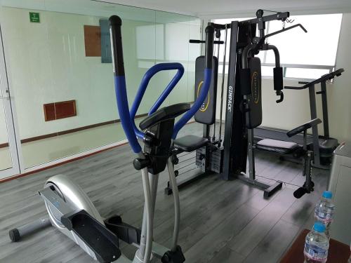 a gym with several tread machines in a room at Best Western Plus Gran Marques in Toluca