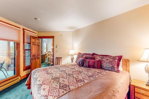 a bedroom with a large bed and a balcony at Lodge at Steamboat C301 in Steamboat Springs