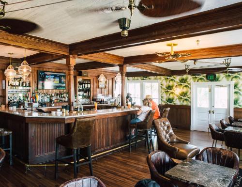 a bar in a restaurant with people sitting at it at The Gibson Inn in Apalachicola