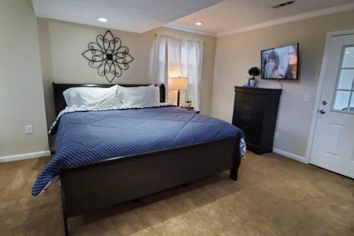a bedroom with a large bed with a blue comforter at Pet Friendly Home with Fenced in Yard in Bethany