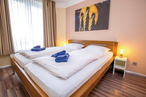 ein Schlafzimmer mit 2 Betten und blauen Handtüchern darauf in der Unterkunft ancora Marina Haus 1 Nr 08, Typ 2 in Neustadt in Holstein