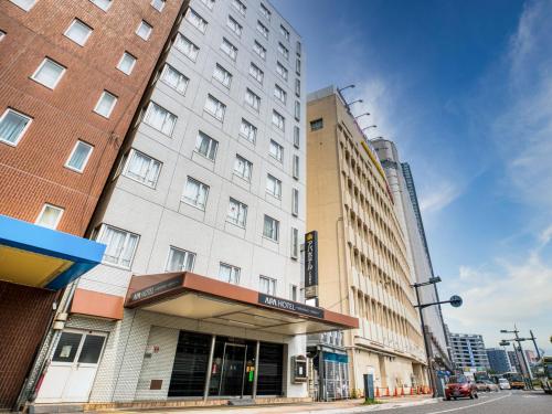 a building on the corner of a city street at APA Hotel Hiroshima Ekimae in Hiroshima