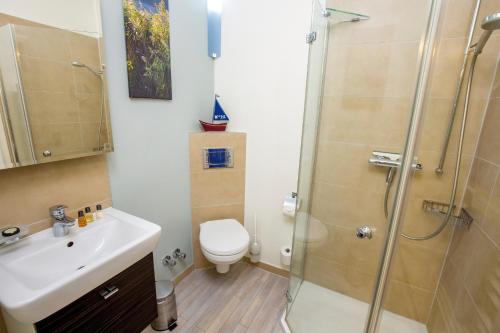 a bathroom with a toilet and a sink and a shower at ancora Marina Haus 2 Nr 01, Typ 1 in Neustadt in Holstein