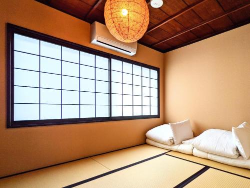 a room with a large window and two beds at INN Plus General Castle Nijo in Kyoto