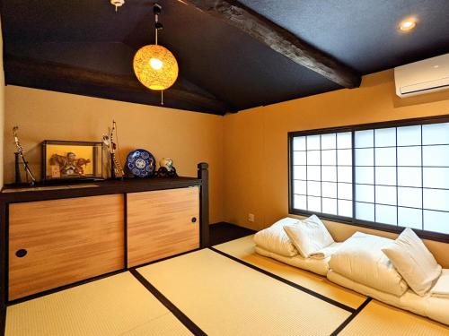 a living room with a couch and a window at INN Plus General Castle Nijo in Kyoto