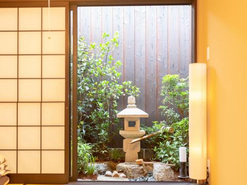 a japanese garden seen through a door at INN Plus General Castle Nijo in Kyoto