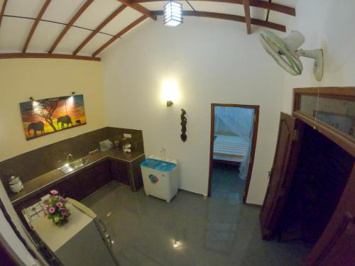 a bathroom with a tub and a sink and a mirror at Villa Girilena in Hikkaduwa
