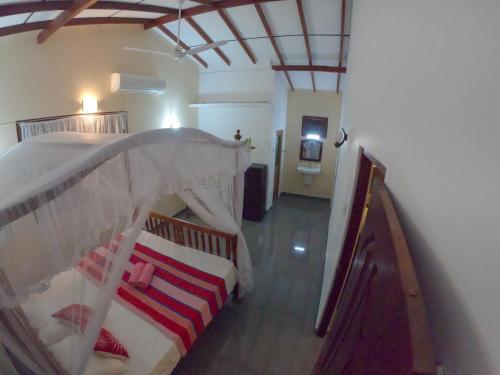 a bedroom with two bunk beds and a staircase at Villa Girilena in Hikkaduwa