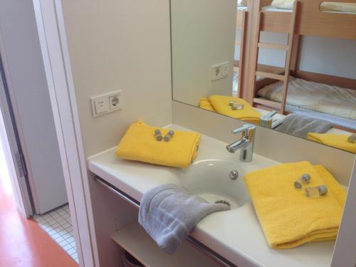 a bathroom with a sink and a mirror at Jugendherberge Stuttgart Neckarpark in Stuttgart