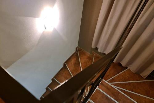 a room with a table and a light on the wall at Двете къщи в планината in Beli Osŭm