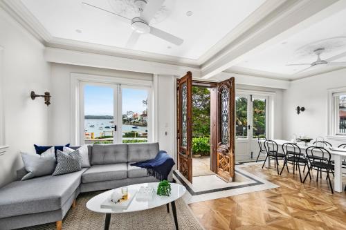 a living room with a couch and a table at Tusan Villa Little Manly in Sydney