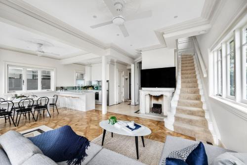 a living room with a couch and a fireplace at Tusan Villa Little Manly in Sydney