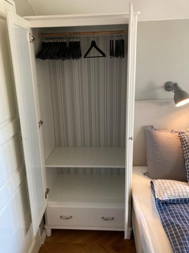 a bedroom with a closet with a bed at Villa Wiegand - a room with a view in Holbæk