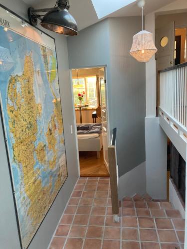 a large map hanging on a wall in a hallway at Villa Wiegand - a room with a view in Holbæk