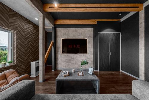 a living room with a couch and a table at The Landscape in Kami-furano