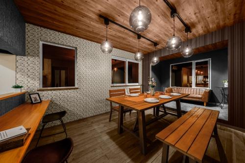 a dining room with a wooden table and chairs at The Landscape in Kami-furano