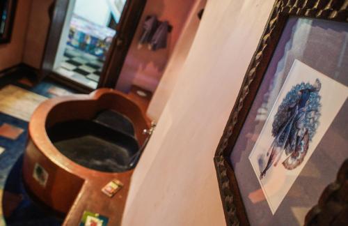 a bathroom with a toilet with a picture on the wall at Emerson on Hurumzi in Zanzibar City