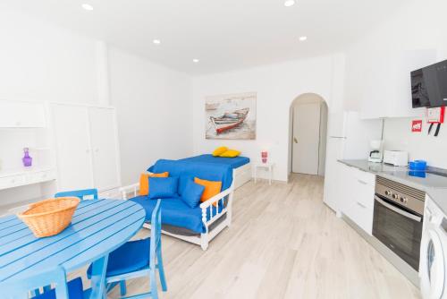 a kitchen with a blue table and blue chairs at Casas Típicas Algarvias in Arroteia de Baixo