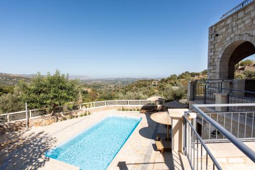 a swimming pool on the side of a building at Prinus Country Retreat Apokoronas, heated pool, 13km from the sea in Embrósneros