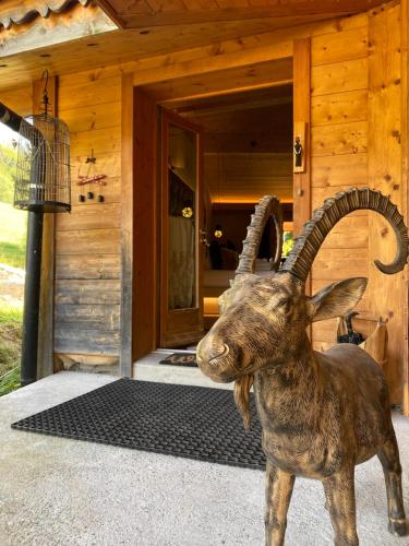 a statue of a ram standing in front of a building at Micro-lodge, Jardin Secret in Montriond