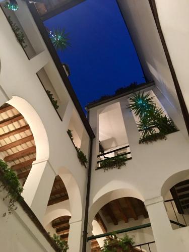 a view of therium of a building at night at RUBRA Apartments in Parma