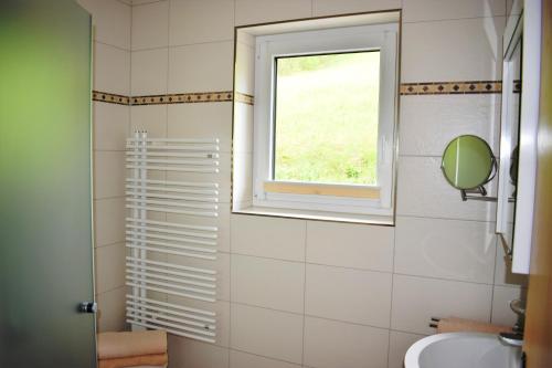 a bathroom with a sink and a window at Ferienwohnung Saalbach Fieberbrunn in Fieberbrunn