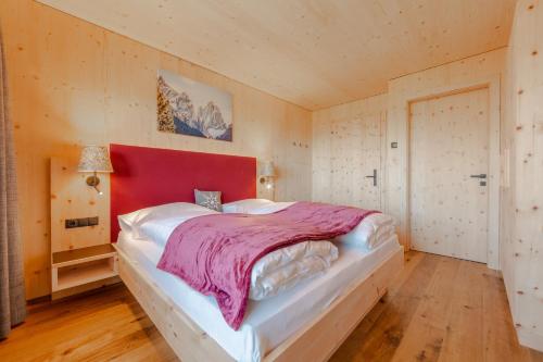 a bedroom with a large bed with a red headboard at Panorama in Sesto