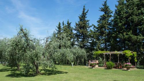 a garden with trees and a gazebo at Agriturismo Podere La Casa in Palaia