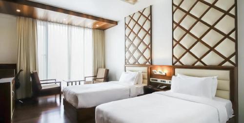Postel nebo postele na pokoji v ubytování Hotel Preethi International