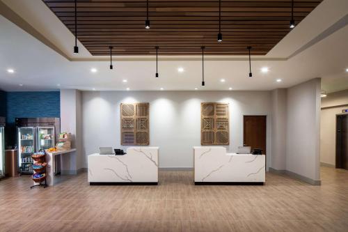 a room with two white desks in a building at Hyatt House North Scottsdale in Scottsdale