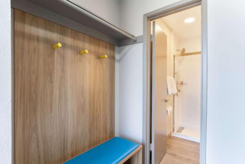 a bathroom with a blue bench and a shower at Days Inn by Wyndham Red Bluff in Red Bluff