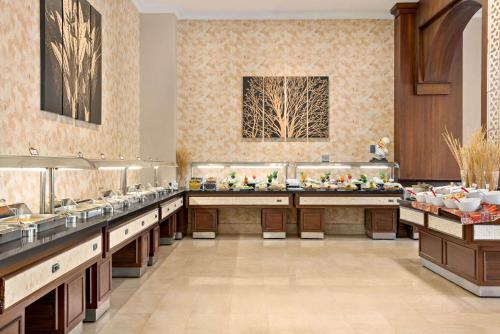 a restaurant with a buffet line with food at Ramada Plaza by Wyndham Mardin in Mardin