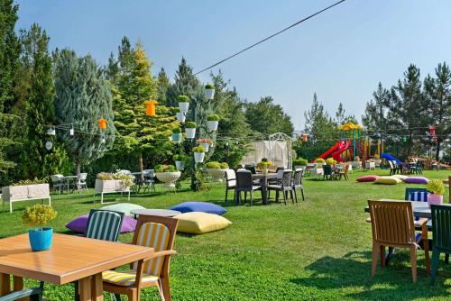 a group of tables and chairs in a park at Ramada Plaza by Wyndham Mardin in Mardin