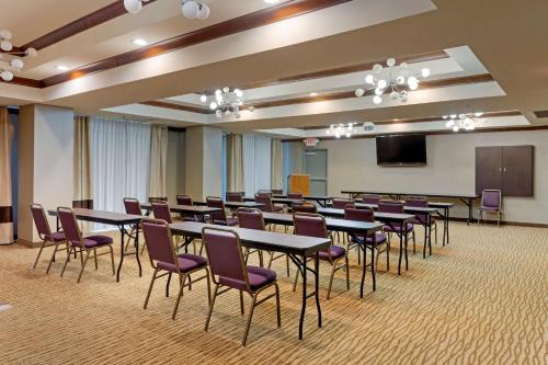 a conference room with tables and chairs and a podium at Comfort Suites Little Rock West in Little Rock