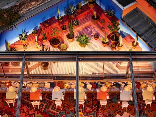an overhead view of a restaurant with plants on the ceiling at Mama Shelter Marseille in Marseille