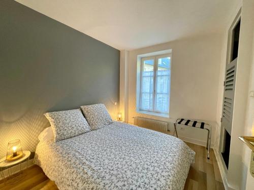 a bedroom with a bed and a window at Le Monastère in Bayeux